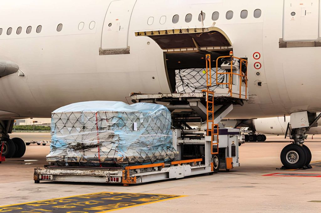 Palletized cargo being loaded onto an aircraft for air freight.