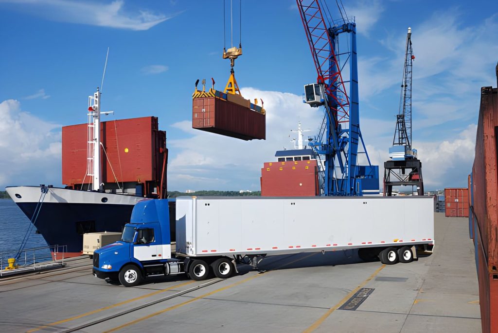 Crane lifting a shipping container beside a cargo ship and freight truck, illustrating NVOCC shipment planning